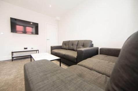 Bright, neutral living room with two comfortabl...