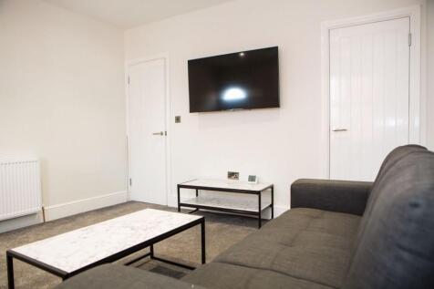 Bright, modern living room with a wall-mounted ...