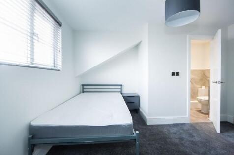 Bright, simply furnished bedroom with a single ...