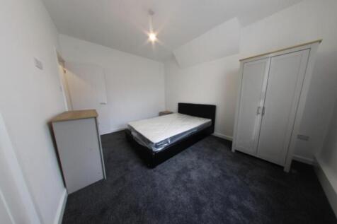 Bright, neutrally decorated double bedroom with...