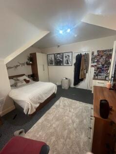 Bright, neatly arranged double bedroom with a c...