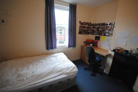 Bright, simply furnished bedroom with a double ...