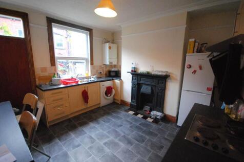 Bright kitchen with fitted cabinets, freestandi...