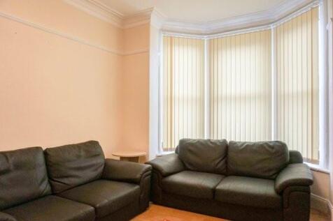 Bright, well-presented living room with a large...
