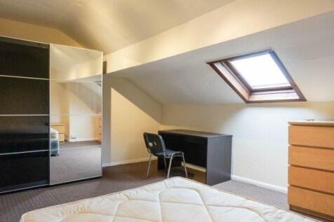 Bright attic bedroom with a skylight, fitted st...