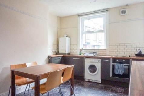Bright kitchen with a dining table and four cha...