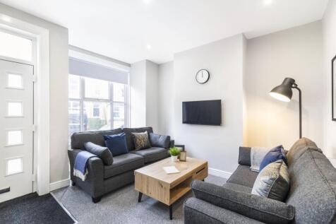 Bright, contemporary living room with two comfo...