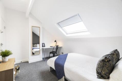 Bright attic bedroom with a skylight, neat sing...