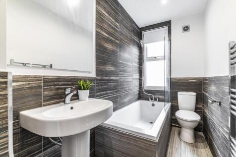Bright modern bathroom with a white basin, bath...