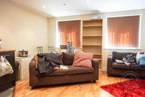 Bright, comfortable living area with two sofas,...