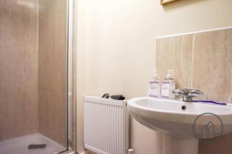 Bright, modern bathroom with walk-in shower, pe...