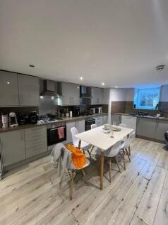 Bright modern kitchen with grey fitted units, i...