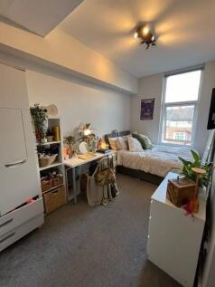 Bright, neatly arranged bedroom with a cosy dou...