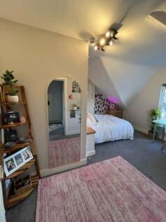 Bright, cozy double bedroom with angled ceiling...