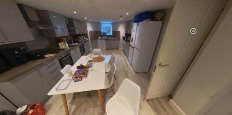 Bright modern kitchen with integrated appliance...