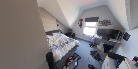 Bright, furnished bedroom with a double bed, st...
