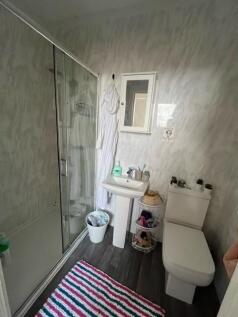 Bright, modern bathroom with a walk-in shower, ...