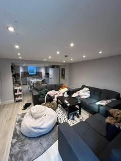 Spacious open-plan living area with a large L-s...