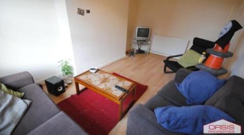 Bright, simply furnished living room with two s...