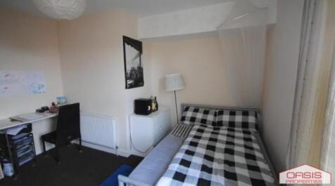 Bright, neatly presented bedroom with a pattern...