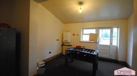 Communal lounge with a foosball table, neutral ...