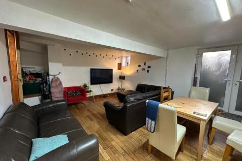 A spacious, well-lit and inviting living room f...