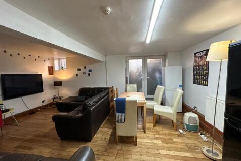 A spacious and modern living room featuring com...