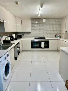 Modern and bright kitchen with clean white cabi...