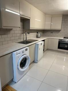 A modern and well-maintained kitchen with white...
