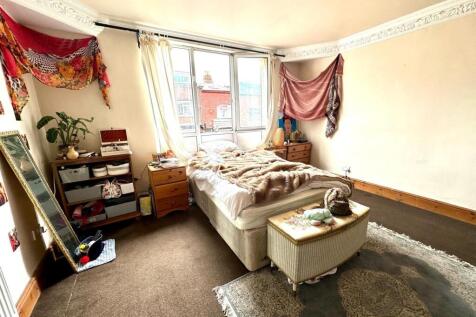 Spacious master bedroom with large windows prov...