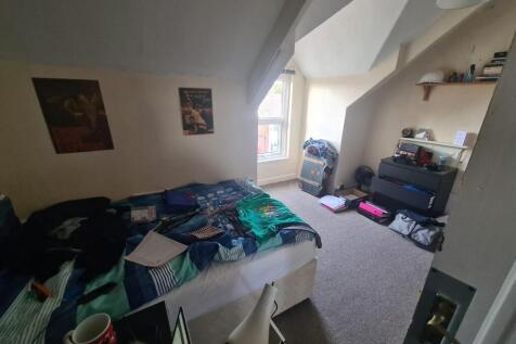 Bright, furnished bedroom with a double bed, bu...
