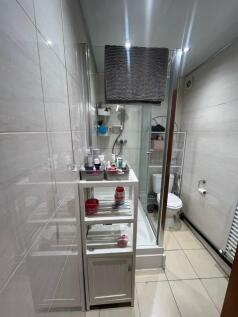 Bright modern bathroom with a shower cubicle, t...