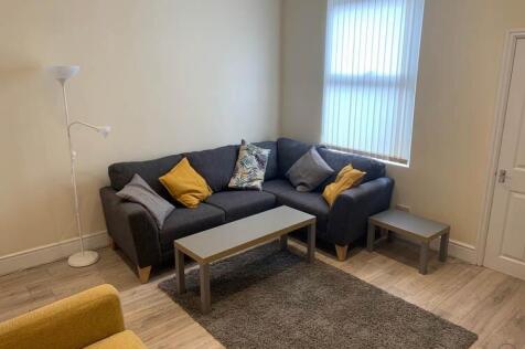 Bright, modern living area with a comfy L-shape...