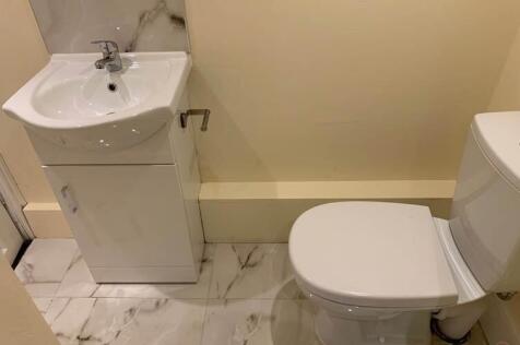 Clean modern bathroom with marble-effect floor ...