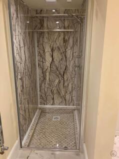 Modern tiled shower enclosure with patterned ma...