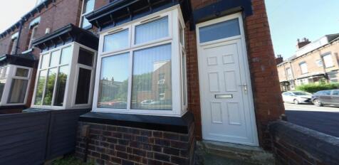 Brick-fronted terraced house entrance with bay ...