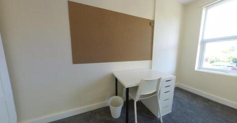 Bright single bedroom with a study area, desk a...