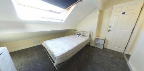 Bright attic bedroom with a roof window bringin...