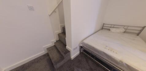 Compact interior showing a carpeted stairwell l...