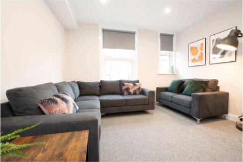 Bright, modern living room with two comfortable...