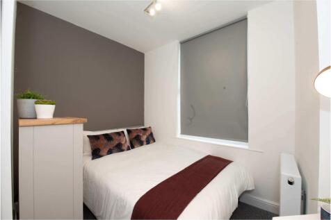 Bright, neatly presented bedroom with a comfort...