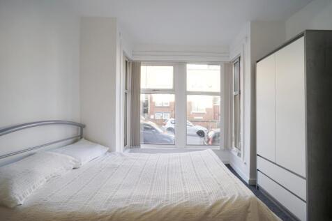 Bright, neatly presented bedroom with a large w...