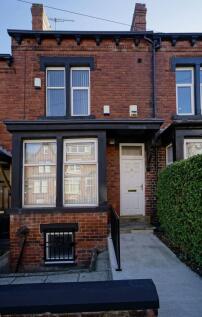 Red-brick terraced house with bay window and a ...