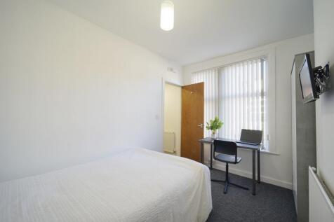 Bright, neatly presented bedroom with a comfort...