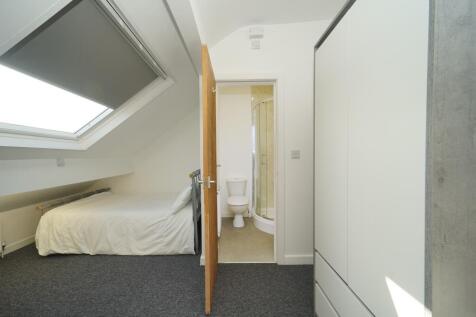 Bright attic double bedroom with a sloped skyli...