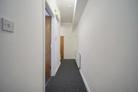 Clean, simple interior hallway with neutral whi...