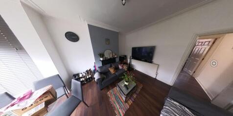 Bright, contemporary living room with wood-effe...