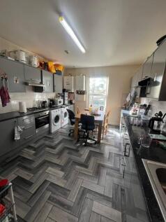 Bright, modern shared kitchen with grey fitted ...