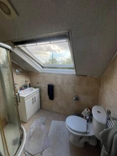 Bright upstairs bathroom with a large skylight ...