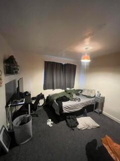 Brightly lit bedroom with a double bed, workspa...